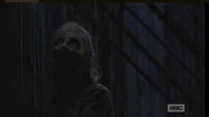 The walker seems to be bolstered by its recent feed, and it seems to smell the flesh and blood of the living on the other side of those steel panels.