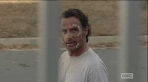 Rick passes by Deanna, makes eye contact with her, but neither one greets the other as Rick passes.