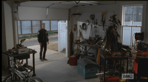 As Rick Grimes stands there, still searching for the words, the garage door begins to roll down in front of him.