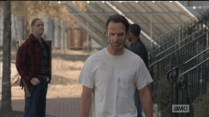 Rick and Tobin greet each other as Rick passes. It is safe to assume the men with Tobin are armed as well, and Rick is most certainly packing his heat. When I first watched this episode, I thought Rick was carrying his pistol openly on him, but rewatching it, I am not sure if it's open, or hidden, but it most certainly is on him.