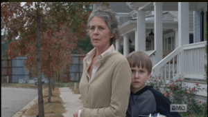 Terrified, Sam hides behind Carol. Many TWD fans speculated on Sam's choosing Carol over his own mother for comfort and protection.