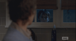As Carol struggles to find the words, a little face peers in the window...it's Sam. He looks at Carol through the window.