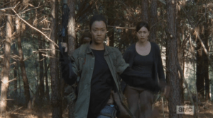 Sasha, unafraid, quickly pulls off her pack as she strides towards the walker pack, ready 2 rumble.