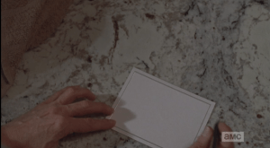 Carol pauses above the blank notecard...
