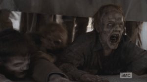 The walkers, however, are not far behind, clawing their way, hissing, towards the men.