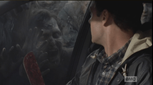 As Daryl counts, Aaron, gripping his machete, turns and locks eyes with one of the walkers, outside. The walker seems to be smiling at Aaron, as if it knows what is happening...