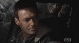 Aaron looks over at Daryl.