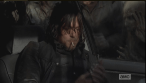 After a moment, Daryl pulls out a cigarette, puts it in his mouth, and reaches in his jacket, fishing for a light.