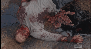 Gabriel walks over to Eat Me Walker's chomped victim, who lay convulsing on the ground...