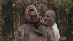 Crying, hating himself, Gabriel pulls at Eat Me Walker's hanging noose end until the walker's head pops off its rotten neck. So much for self sacrifice.