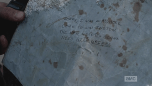 ...who takes the map Morgan has handed him, and looks down to see Abraham's note to Rick: