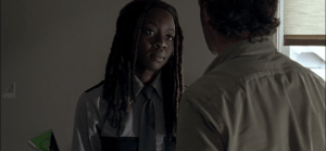 Michonne's face softens as she looks at the big adorable dummy in front of her.