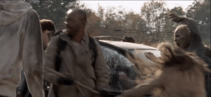 Brandishing his trusty wooden staff, Morgan continues taking out walkers, buying Aaron and Daryl a moment to get out of the car and begin battling walkers themselves.