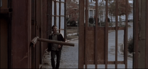Outside, Rick walks quickly towards the gate, which is open...he checks all around the fence, peers outside, then sees...