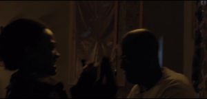 Sasha and Gabriel battle it out, wrestling the gun, which fires an errant shot through one of the chapel windows...