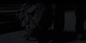 We see one of the wolfboys collect Aaron's dropped bag from the ground at the distribution center...