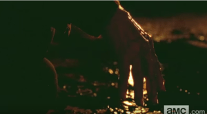 Deanna Monroe's bloodied hand, hanging limply, as the dying fire in the chiminea reflects in the pool Reg's blood.