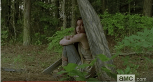 ...huddled behind the meager refuge of a felled wooden sign.