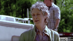 Not to be deterred, clad in her button-down uniform or conformity, Junior League Carol smiles in the next clip, demurs,