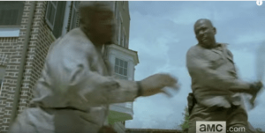 TWD fan theorists also echoed my suspicions that this individual who Morgan is smacking the fuck down looks more like a live person than a walker...a live member of the Wolves, perhaps. It is also being suggested that Morgan's