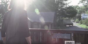 We see a shot of what looks like Deanna, standing within the relative safety of Reg's steel wall, with a handmade sign commemorating the first panel of the wall, signed 
