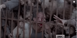 ...as some poor man is pressed up against what looks like Alexandria's gate, bleeding as so many walkers surround him and begin their ungodly feasting. Ugh, poor dude!