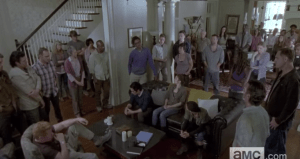 Among the faces in the group, we see familiar ones from our sweet gang, as well as Alexandrians we recognize, as well as ones we have yet to meet...many of those assembled are looking down, or at Rick, digesting whatever information, or plan, he is presenting.