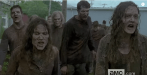 We see a sizeable group of walkers charge forward, teeth bared...