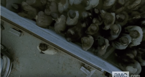 ...and we see Rick press back vainly as the wall starts to rock, and give way to the press of walkers...gulp!