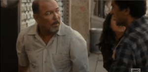 Travis sees a barber pulling down the metal door over his storefront, and quickly asks the man if they can take refuge inside his shop.