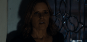 ...only to be blocked by her mother, who stands with her back to the door, immovable.