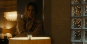 Nick shifts uncomfortably, stays silent, as Liza shoots Travis an irritated, knowing look as she walks past him.