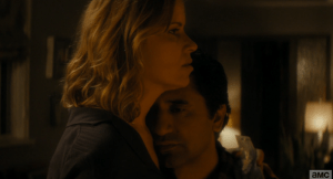 Travis comes in, and the two share a cuddle as he tells her he had to bring the Salazars.