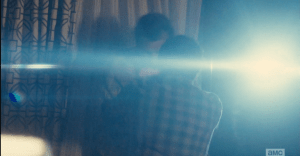 ...the shine of a flashlight on the other side of the sliding glass door appears.