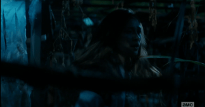 The young woman stops, looks around, seemingly lost.