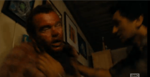 ...Travis shoves Dawson B. Infected up against the wall.