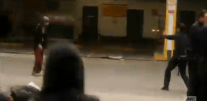 The first shot pierces the body of the young woman in the chest, which of course does not stop the walker. The officer fires again...