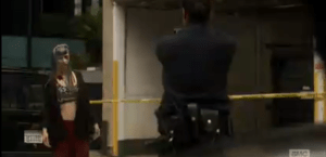 ...this time, nailing the walker in the eye. The reanimated young woman slumps to the ground amidst screams from onlookers.