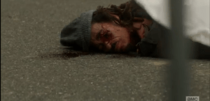 We see the homeless man who police shot, a bullet hole through one eye, and what looks like a gored-open wound in the front of the dead man's neck...it is easy to surmise that the homeless man fell prey to a walker attack, reanimated, and was put down by police.