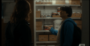 They open the doors to the cafeteria's pantry, to reveal a stocked larder of canned goods.