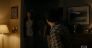 Travis, looking majorly freaked, turns to Liza and tells her quickly to take Chris and get back to the car, now.