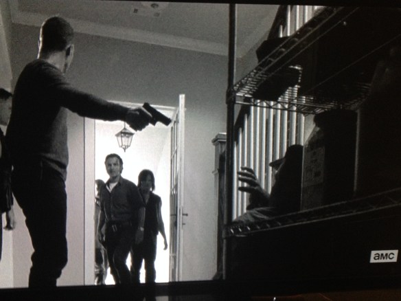 Just then, the door opens, and there stands Rick Grimes, flanked by Daryl and Morgan.
