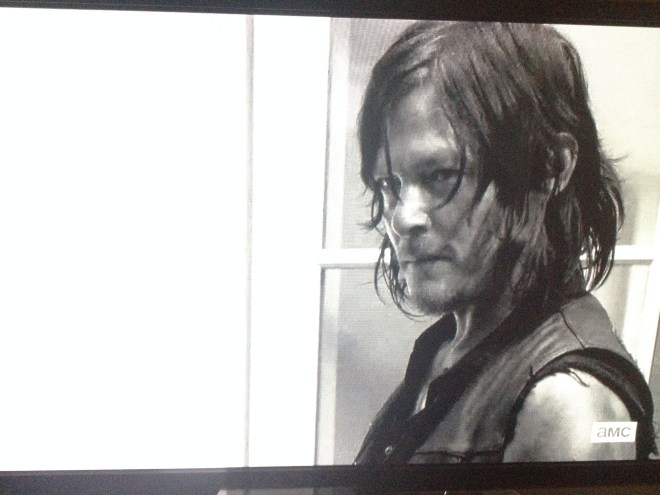 Daryl looks up at Rick.
