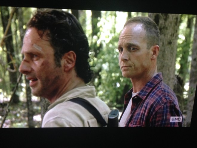 As they hide behind the trees, surveying the walkers, Carter says,