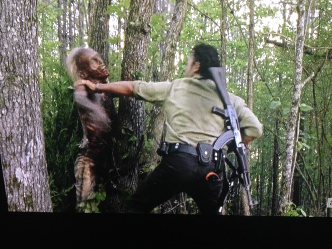 ...Rick quickly dispatches the tree walker with his knife.;