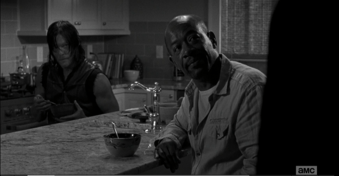 As Daryl watches the exchange, Morgan looks down, registering Rick's meaning. He looks back up at Rick.