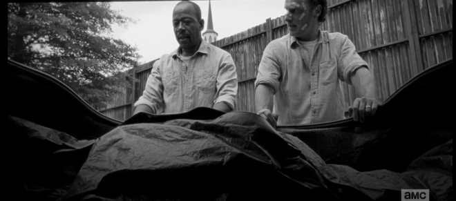 Later, as they load Pete's body into the car trunk, Rick looks over at Morgan.