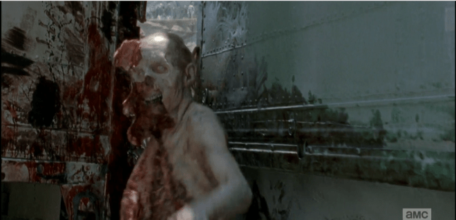 As the walker gets shoved through the narrow opening between the trucks, we see how its skin and soft tissues tear away easily from the bones. Greg Nicotero, you beautiful madman!