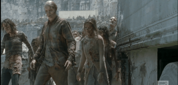 As one of the trucks pulls away, according to plan, the walkers spill out of the opening.