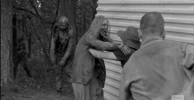 Carter, I think, puts down his shovel (dude, seriously...you're killing me, here) as another Alexandrian shoves a walker away.